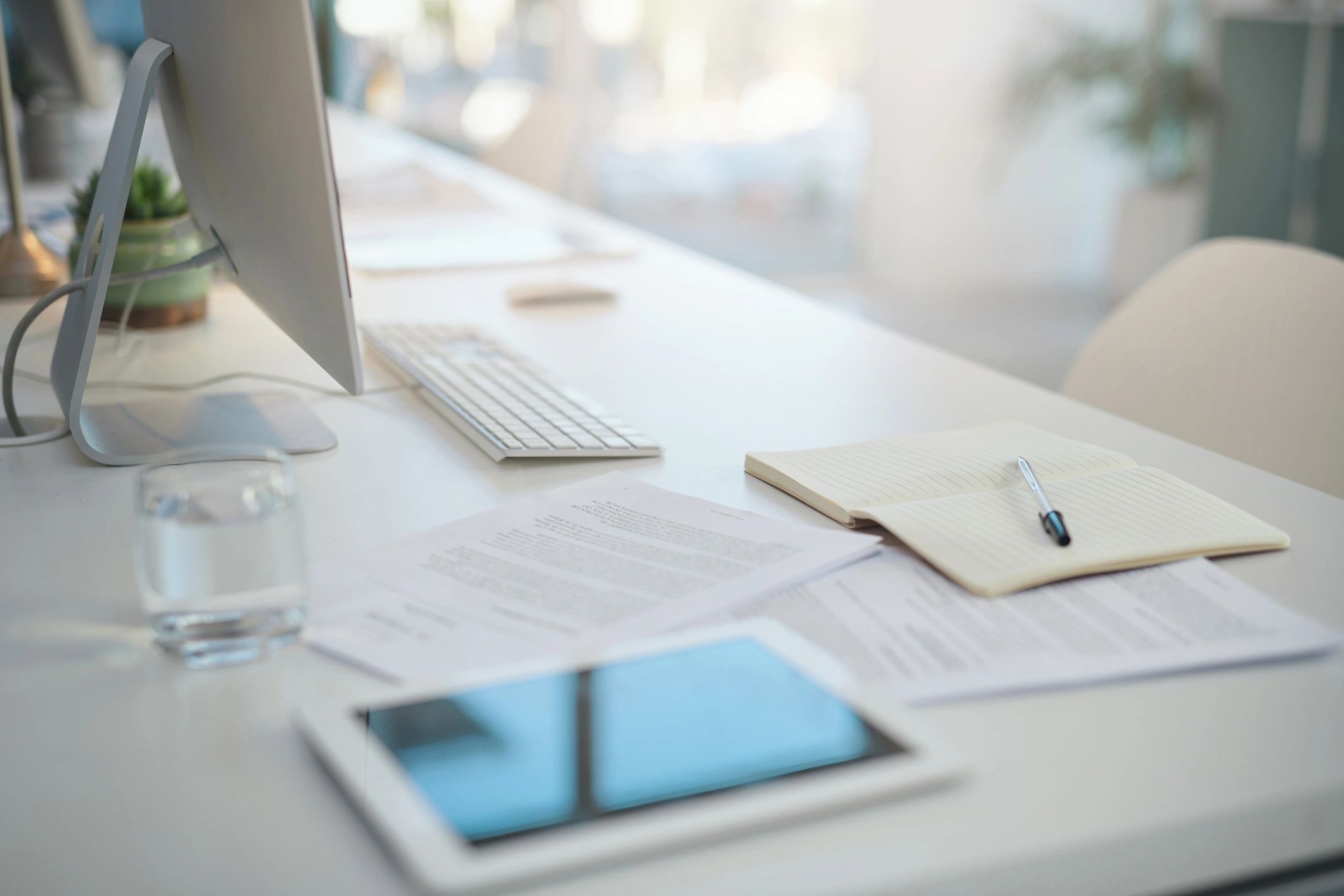 Modern office desk with documents and workspace items