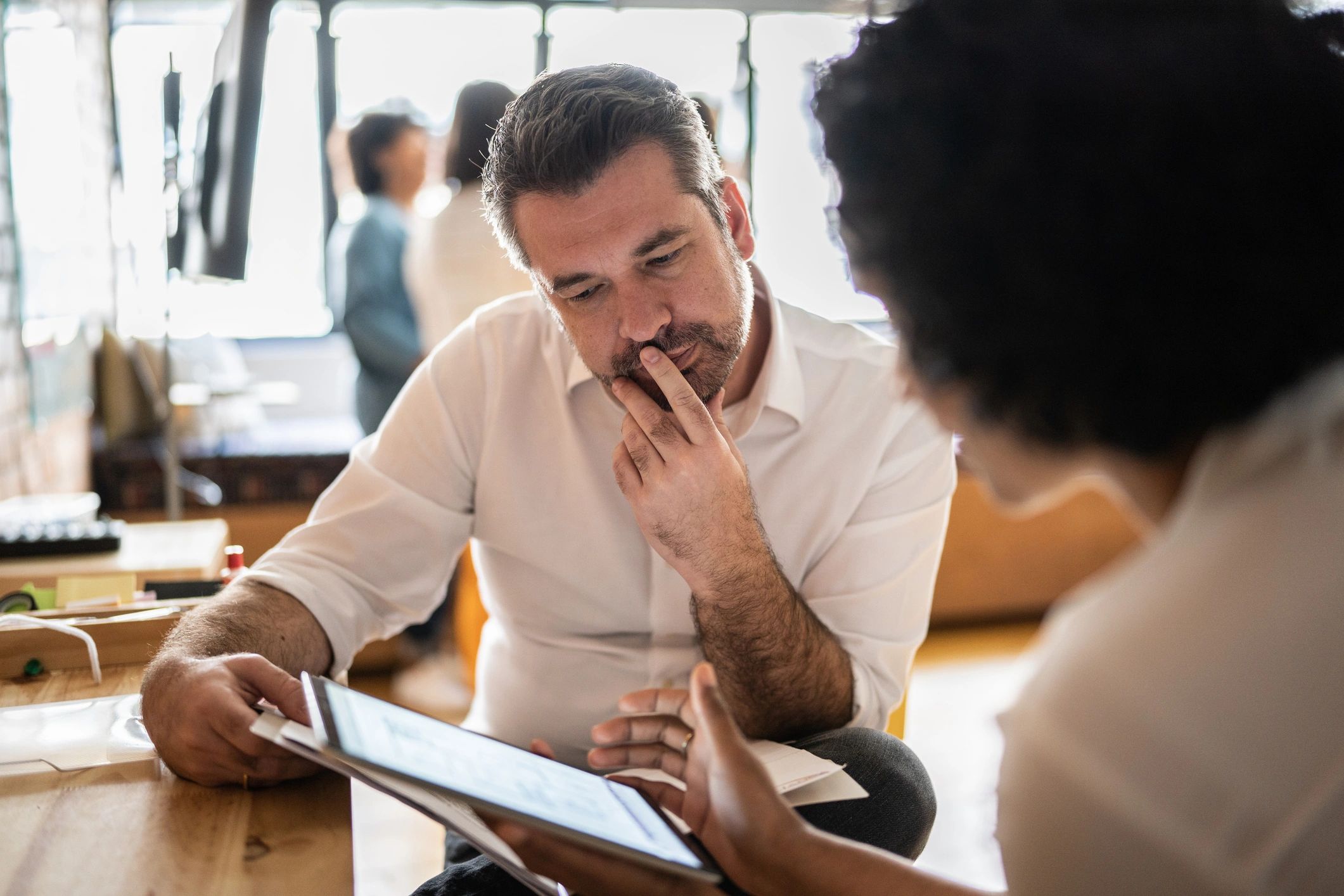 Small business owner reviewing financial reports with a bookkeeper