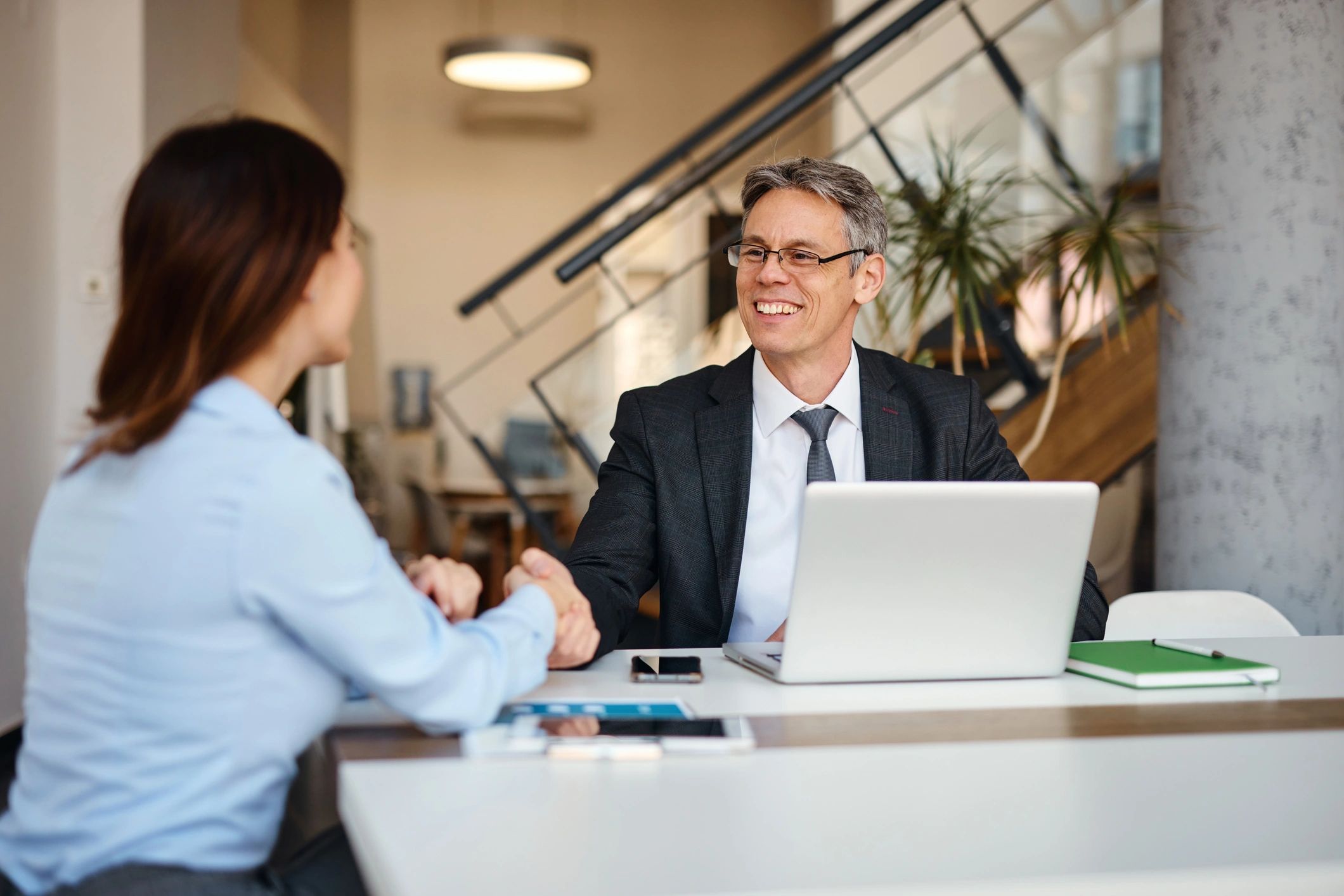 Bookkeeper meeting a small business owner and shaking hands in an office